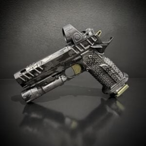 Semi-automatic pistol with camouflage finish and tactical red-dot sight on a dark background image.