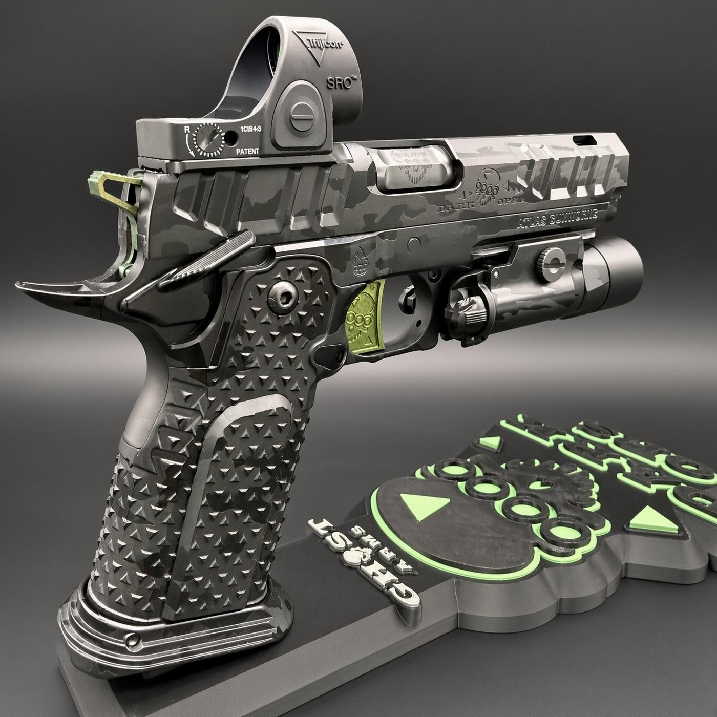 Detailed sci‑fi handgun on a display base, camo finish with tactical accessories and a bright green control panel nearby.